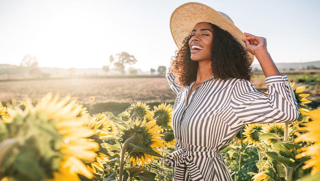 Female Model in Sun Hat in a sun flower field