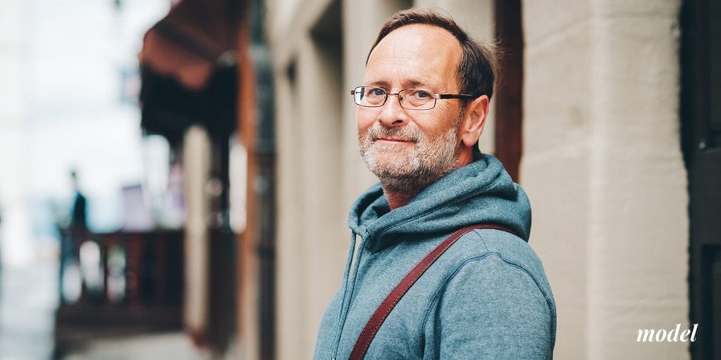 Middle Aged Man In Hoodie Sweater Looking to his Left at the Camera